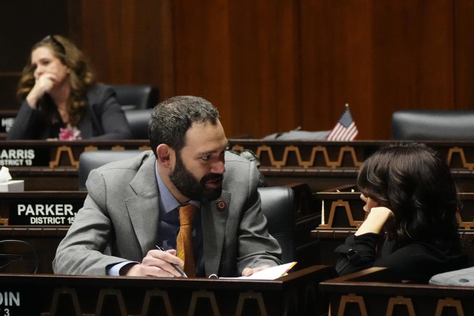 Rep. Alexander Kolodin (L) speaks with Rep. Rachel Jones during a legislative session at the Arizona state Capitol in Phoenix on March 21, 2023.