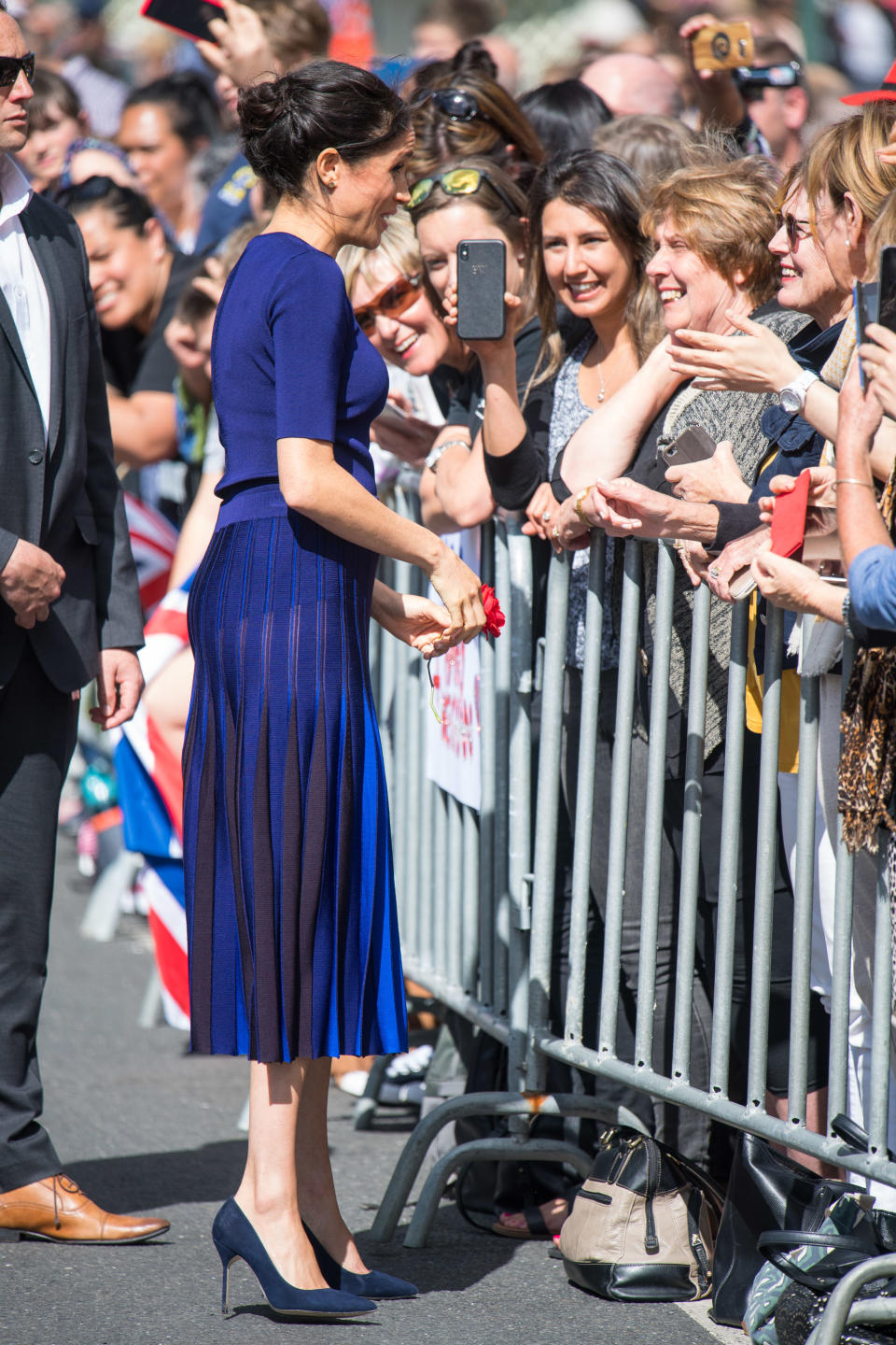 Meghan wore a bespoke Givenchy navy pleated skirt. Photo: Getty Images