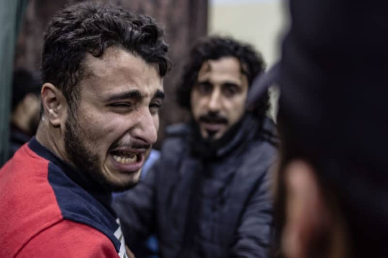 A man cries after his brother was injured following artillery shelling by the Syrian regime which killed two men and injured many more. Anas Alkharboutli/dpa