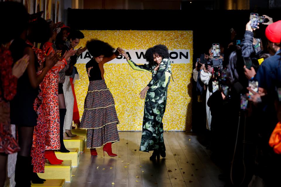 Pat Cleveland and designer Marisa Wilson dance down the runway of Wilson's presentation during New York Fashion WEek.