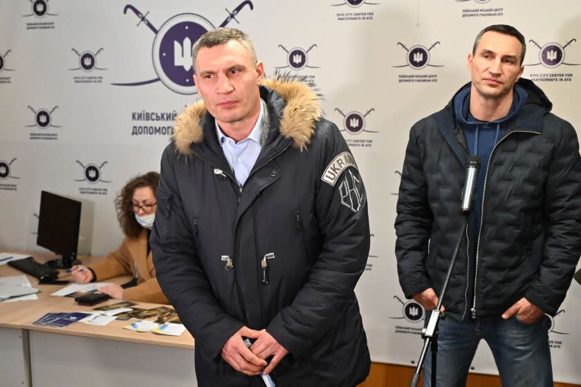 Kyiv mayor Vitali Klitschko (L) and his brother and former Ukrainian boxer Wladimir Klitschko (R) speak to the press during visit to a volunteers recruitment centre in Kiev on February 2, 2022. - Kyiv mayor and former world heavyweight champion boxer Vitaly Klitschko along with his brother, fellow champion boxer, Wladimir visited a recruitment centre for volunteers willing to take up arms if the capital is attacked. (Photo by Genya SAVILOV / AFP) (Photo by GENYA SAVILOV/AFP via Getty Images)