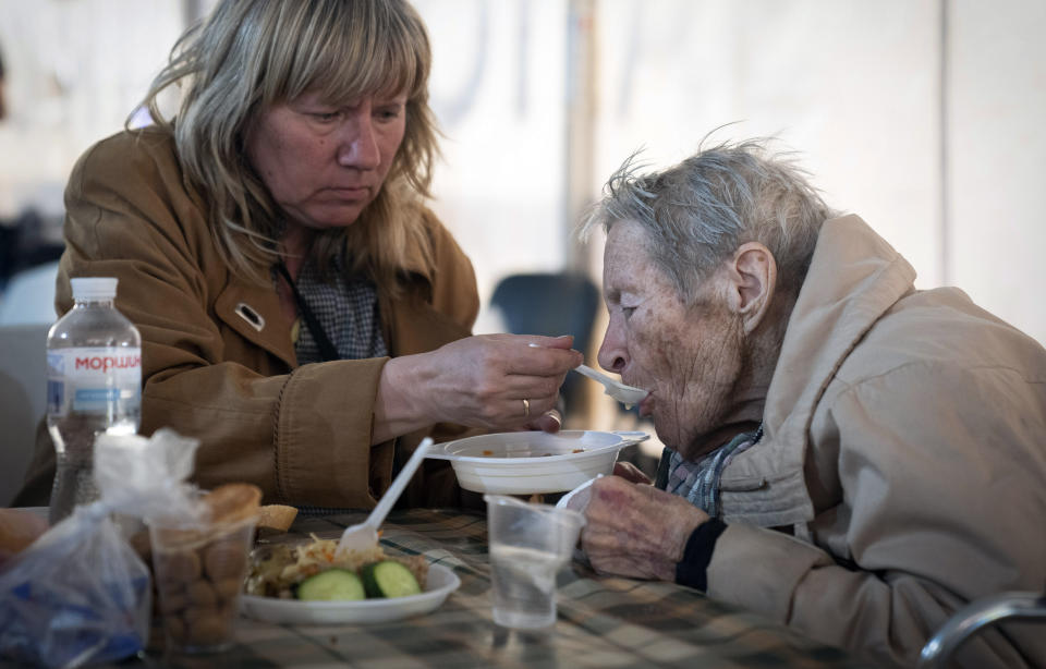 FILE - People have a meal after arriving from the Ukrainian city of Mariupol at a center for displaced people in Zaporizhzhia, Ukraine, Tuesday, May 3, 2022. With the evacuation of some civilians from a sprawling steel mill besieged by Russian forces, attention is turning to the fate of hundreds of Ukrainian troops still inside after weeks in the warren of underground tunnels and bunkers. (AP Photo/Evgeniy Maloletka)