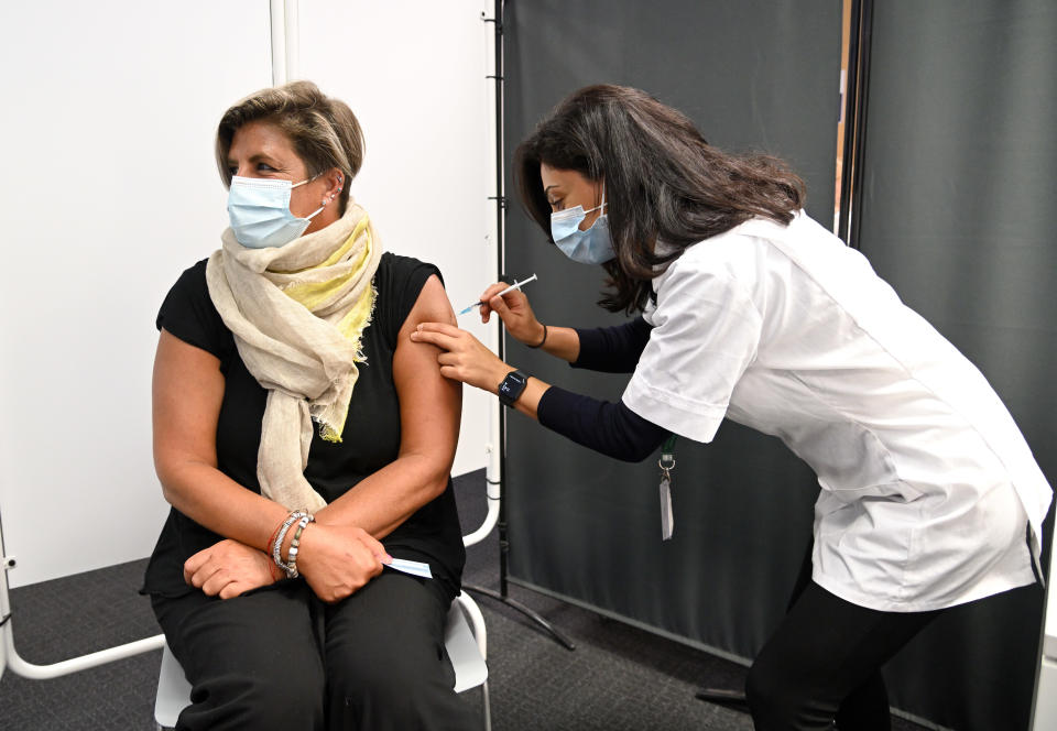 BOREHAMWOOD, ENGLAND - OCTOBER 04: Care worker Jen Madghachian, wife of the photographer, receives her COVID-19 booster vaccination at the MedMart pharmacy on October 04, 2021 in Borehamwood, England. Frontline health and care workers in England are being offered a booster COVID-19 vaccination ahead of the winter months. (Photo by Karwai Tang/Getty Images)