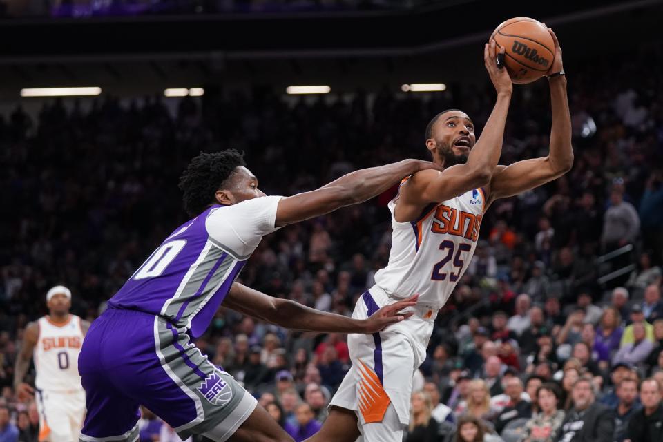 Mar 20, 2022; Sacramento, California, USA; Phoenix Suns forward Mikal Bridges (25) is fouled by Sacramento Kings center Damian Jones (30) in overtime at the Golden 1 Center.