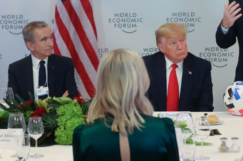 LVMH CEO Arnault sits with U.S. President Trump during a dinner for corporate chief executives alongside the World Economic Forum in Davos, Switzerland