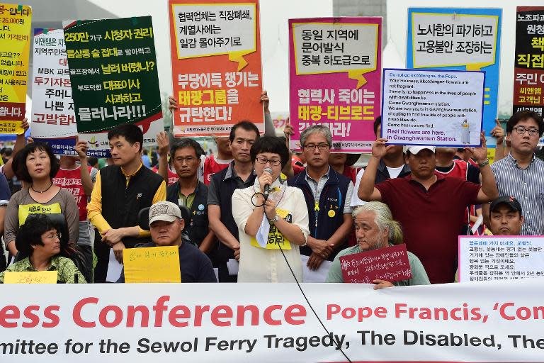 Protesters and relatives of the Sewol ferry disaster hold a joint press conference urging Pope Francis to pray with them at Gwanghwamun Square in Seoul on August 5, 2014