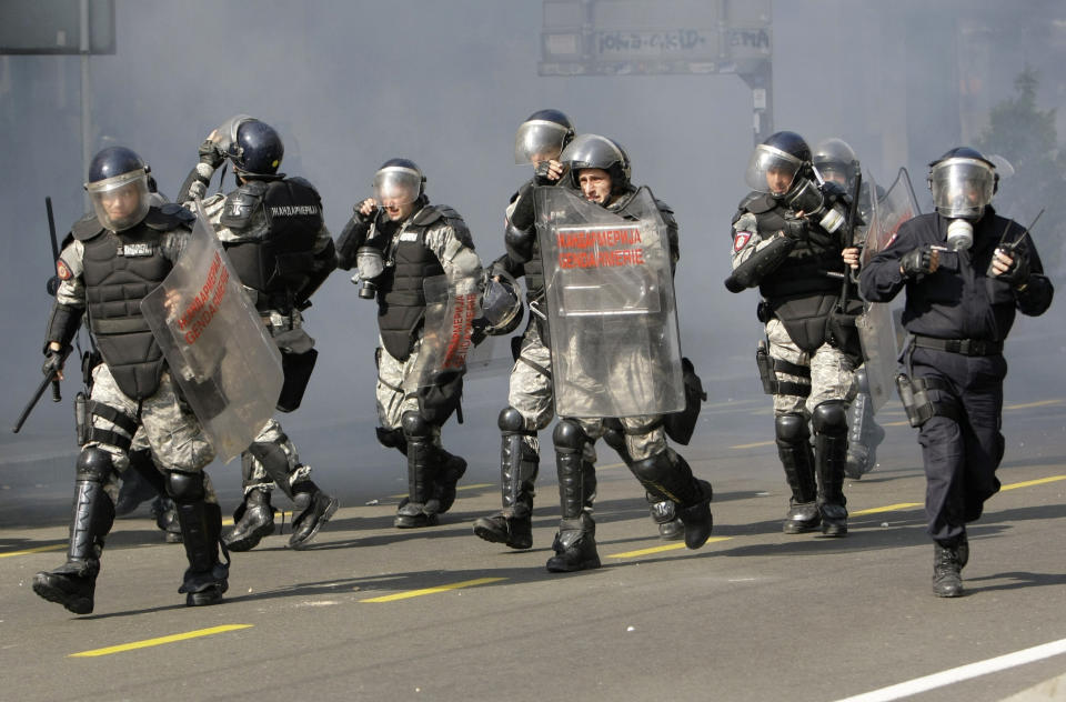 FILE - Protesters throw stones at members of the riot police during the anti gay pride march in Belgrade, Serbia, Sunday, Oct. 10, 2010. Organizers of a pan-European LGBTQ events held in Belgrade this week said Friday they will hold a planned Pride march in the Serbian capital despite a police ban and threats from ani-gay groups. Serbia's police have banned the parade that is planned for Saturday, citing a risk of clashes with far-right activists who also said they will gather in protest. Several legal appeals against the ban launched by the Pride week organizers have been rejected by Serbia's authorities. (AP Photo/Darko Vojinovic, File)