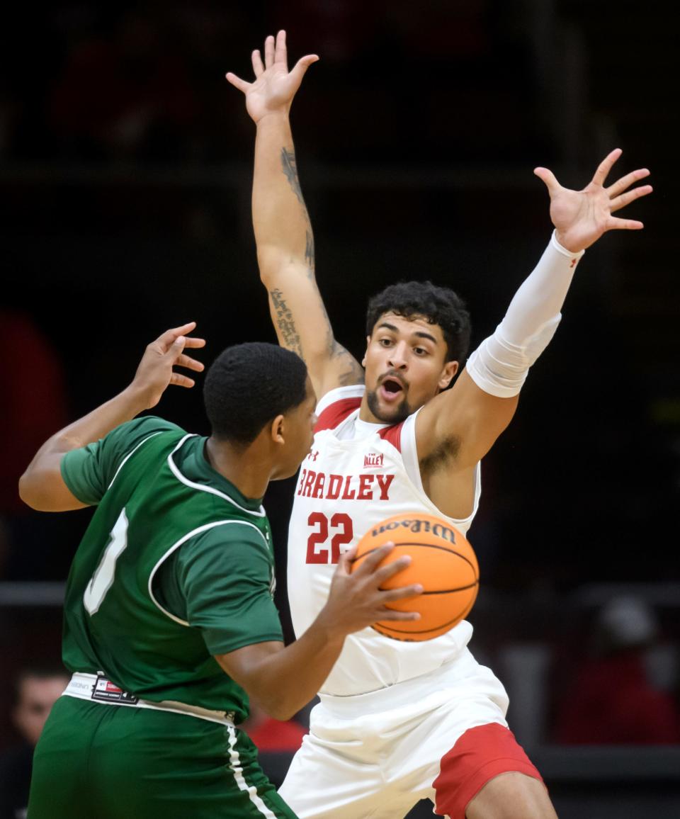 Bradley's Ja'Shon Henry (22) defends against Illinois Wesleyan's Hakim Williams in the first half of their exhibition game Wednesday, Nov. 2, 2022 at Carver Arena.