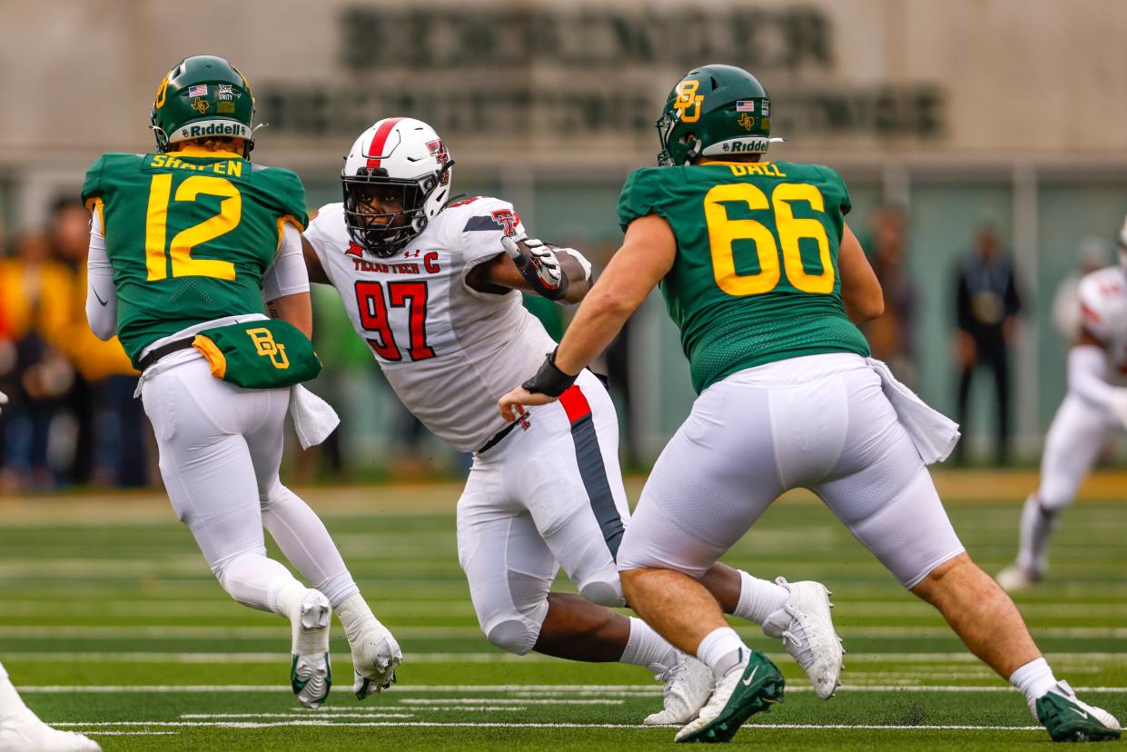 Texas Tech defensive tackle Tony Bradford (97) closes in on Baylor quarterback Blake Shapen (12) during the Bears' 27-24 victory in last year's regular-season finale in Waco. The two teams square off again at 6:30 p.m. Saturday at Jones AT&T Stadium.