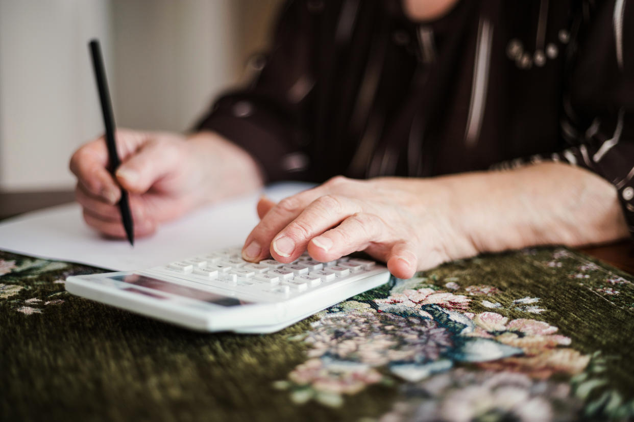 Senior woman with a notebook and calculator