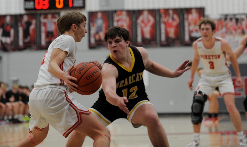 Paint Valley's Braylon Robertson (#12) defends during a game against Piketon on Feb. 3, 2023. Robertson scored 12 points and hit a game-high three 3-pointers as the Bearcats went on to defeat the Redstreaks 65-31.