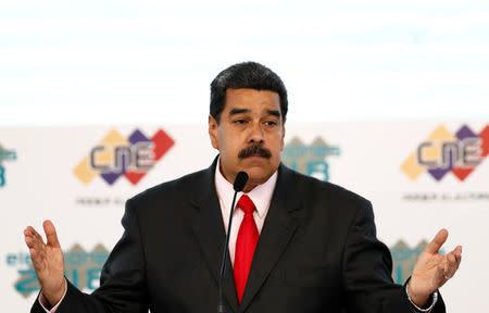 Venezuela's re-elected President Nicolas Maduro gestures after he received a certificate given by the National Electoral Council (CNE), confirming him as winner of Sunday's election, in Caracas, Venezuela May 22, 2018. REUTERS/Marco Bello