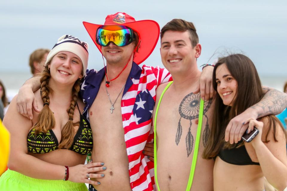 People didn't let early morning showers hinder their chance to participate in the 37th annual Polar Bear Dip at the Flora-Bama on Friday, Jan. 1, 2021.