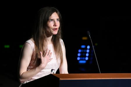 Amanda Knox, who has returned to Italy for the first time since being cleared of the murder of British student Meredith Kercher, reacts as she speaks at the Criminal Justice Festival in Modena