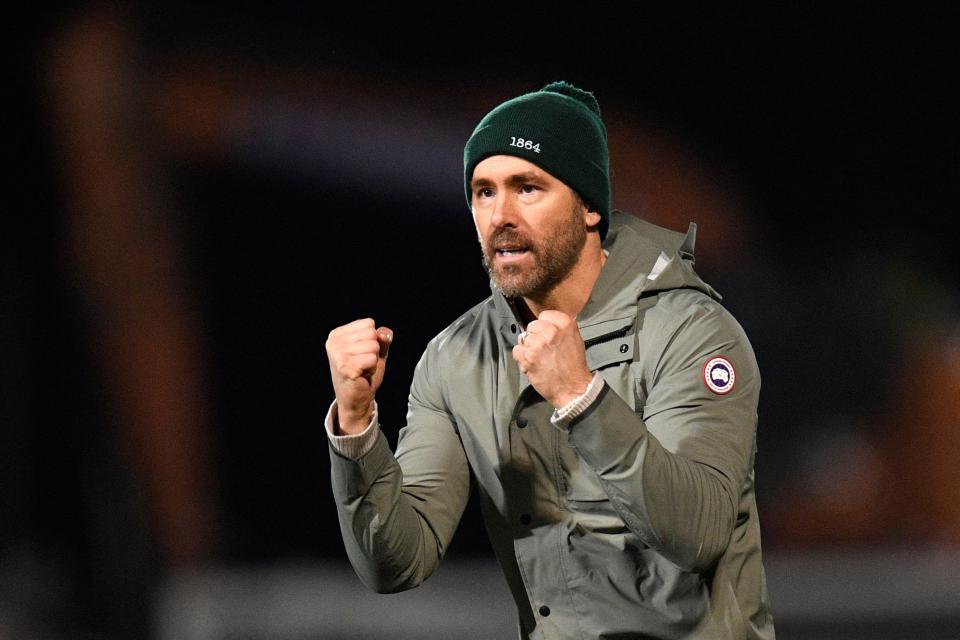 Actor and Wrexham owner Ryan Reynolds acknowledges the fans after the English FA Cup fourth round football match against Sheffield United at the Racecourse Ground Stadium in Wrexham. The match ended in a draw at 3-3.