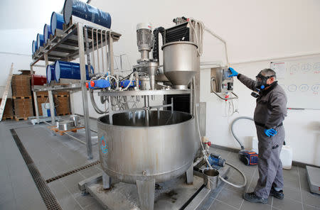 Gerald Grand, staff member at Agolin, Swiss maker of feed additives based on botanical compounds, works on a mixture of components in Biere, Switzerland, September 26, 2018. REUTERS/Denis Balibouse/Files