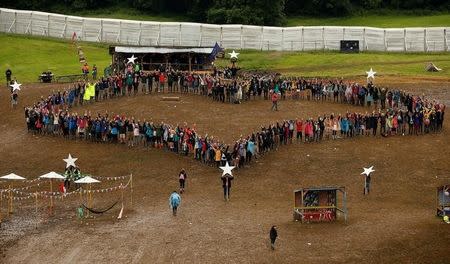 Revellers take part in "EU referendum - Call to action" flash mob at Worthy Farm in Somerset during the Glastonbury Festival, Britain, June 26, 2016. REUTERS/Stoyan Nenov