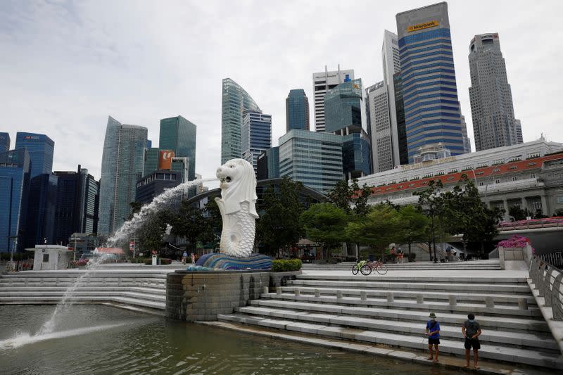 FILE PHOTO: Youth fish at a largely empty Merlion Park in Singapore