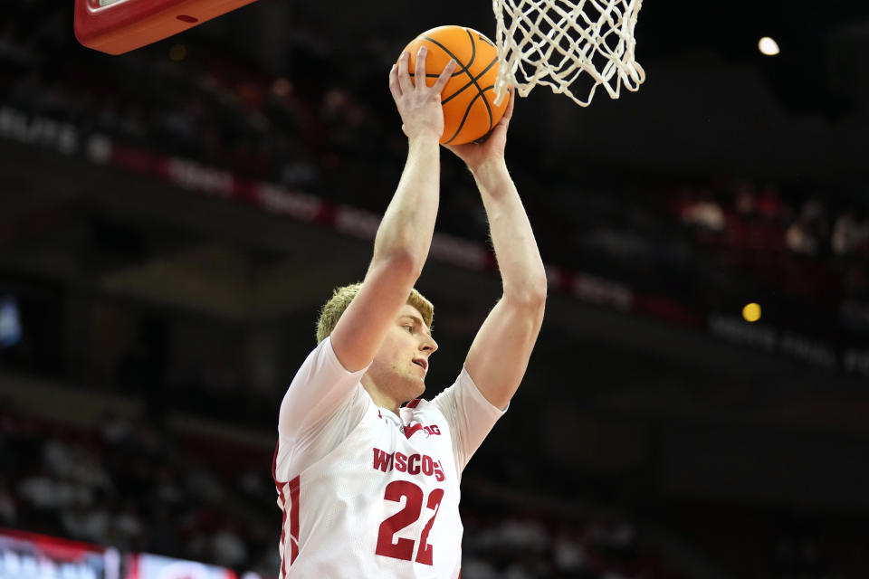 Feb. 22, 2023; Madison; Wisconsin Badgers forward Steven Crowl (22) rebounds the ball during the first half against the Iowa Hawkeyes at the Kohl Center. Kayla Wolf-USA TODAY Sports