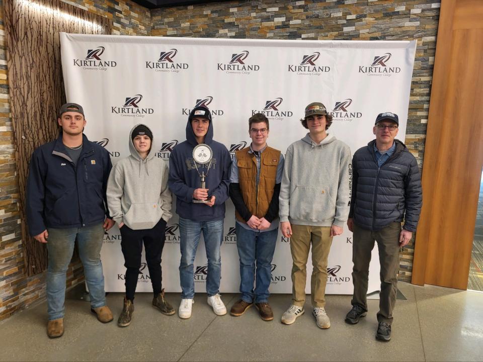 (From left) Petoskey High School seniors JD Cantrell, Brett Kloss, Connor Rice, Chase Goldenstein, Joe Berakovich and automotive program volunteer Dave Birkmeier pose for a photo after the Automotive Showdown at Kirtland Community College on Feb. 16, 2024.