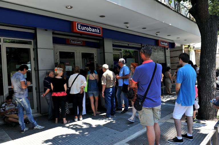 People queue outside a bank in Thessaloniki on July 6, 2015 after voters decisively rejected international creditors' tough bailout terms