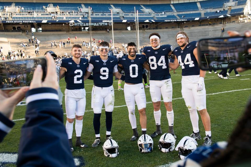 Penn State players Liam Clifford (2), Beau Pribula (9), Dominic DeLuca (0), Theo Johnson (84) and Tyler Warren (44) pose for a group photo following a 27-6 win over Rutgers Saturday, Nov. 18, 2023, in State College, Pa.