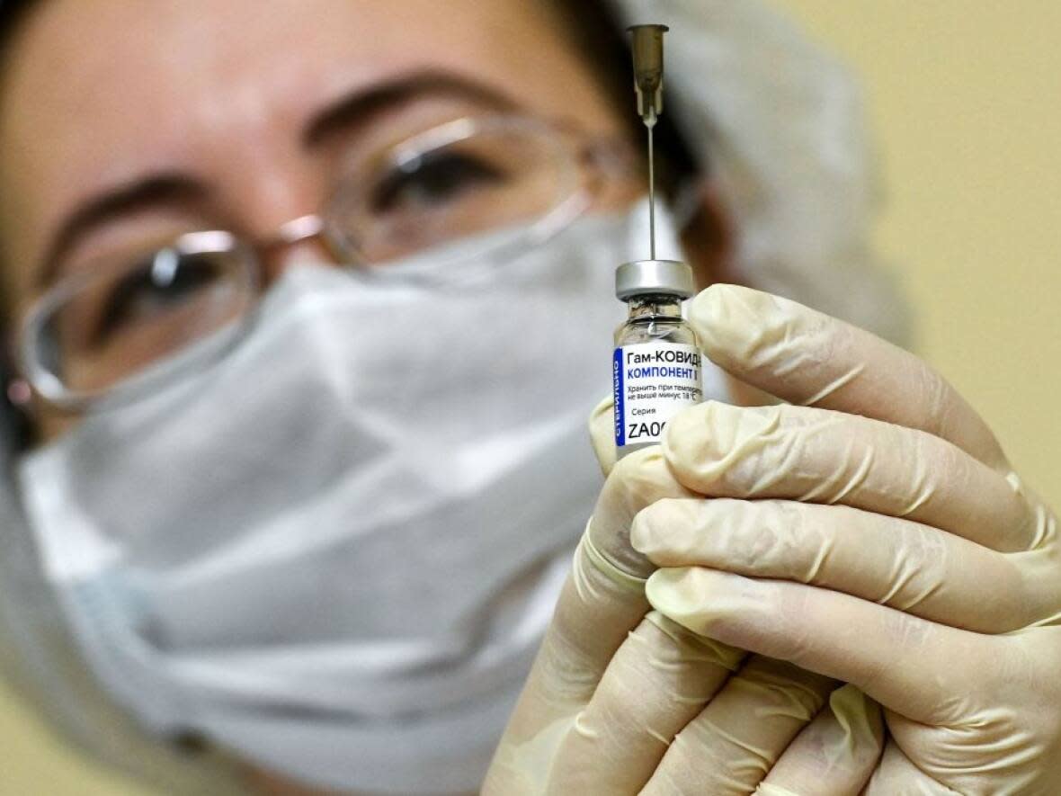 A nurse wearing a face mask prepares a COVID-19 vaccination. (Kirill Kudryavtsev/AFP via Getty Images - image credit)