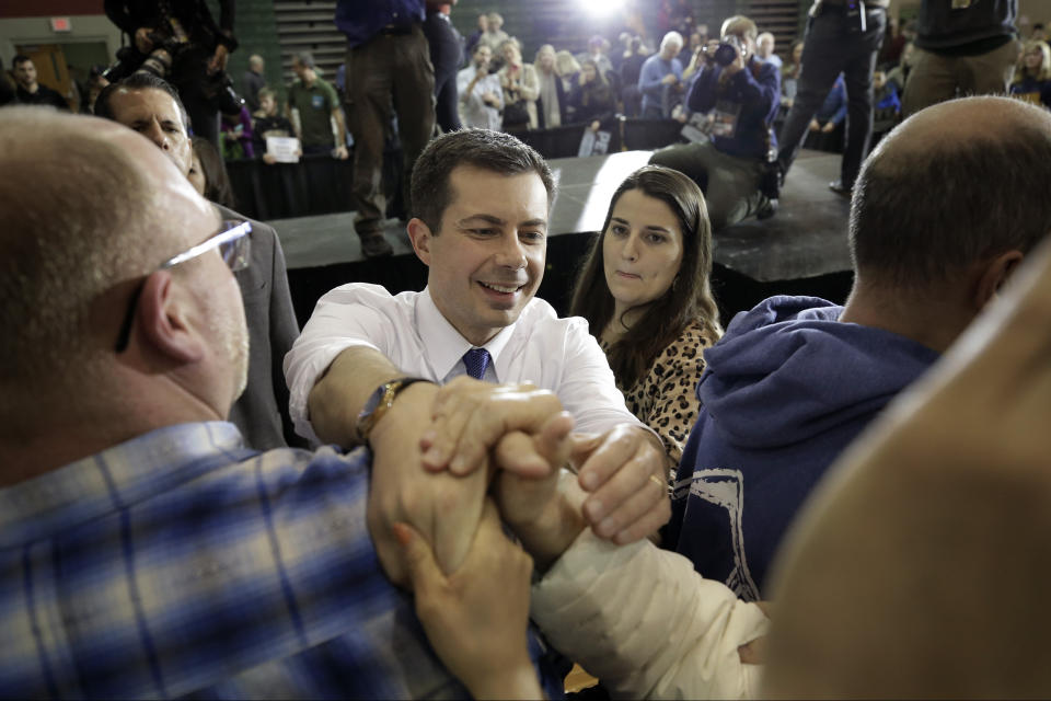 Democratic presidential candidate former South Bend, Ind., Mayor Pete Buttigieg, center, greets people in the audience at the conclusion of a campaign rally, Sunday, Feb. 9, 2020, in Dover, N.H. (AP Photo/Steven Senne)