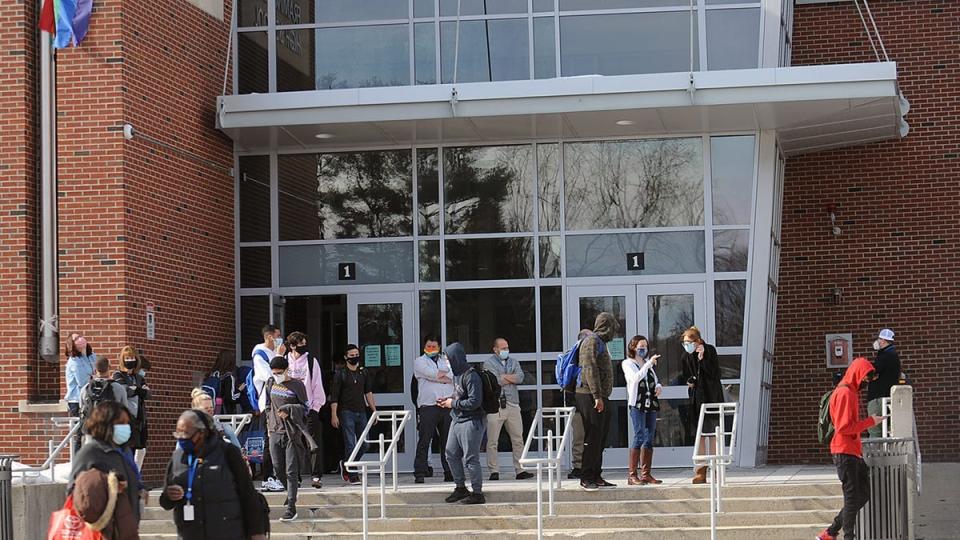 Students leave Framingham High School after the closing bell in March 2021.