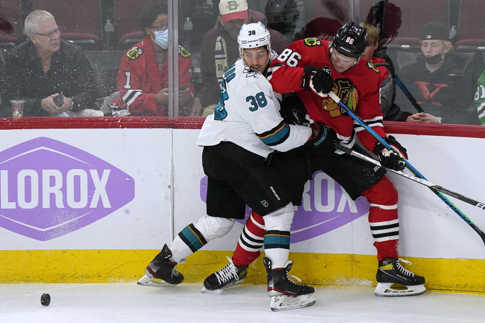 San Jose Sharks defenseman Mario Ferraro, left, and Chicago Blackhawks left wing Mike Hardman battle for the puck during the first period of an NHL hockey game in Chicago, Sunday, Nov. 28, 2021. (AP Photo/Nam Y. Huh)