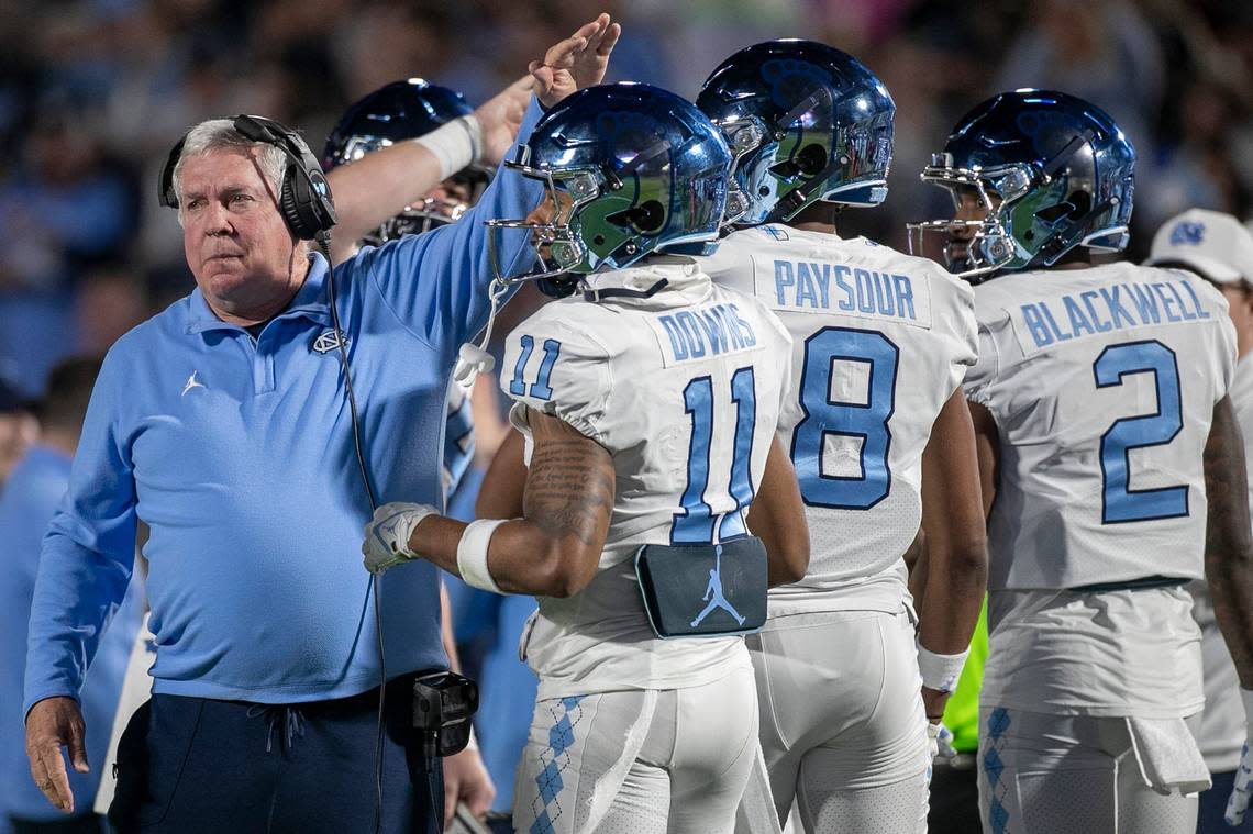 North Carolina coach Mack Brown gives Josh Downs (11) a pat on the head after the Tar Heels’ first touchdown drive on Saturday, October 15, 2022 at Wallace-Wade Stadium in Durham, N.C. Downs had nine catches for 126 yards in the Tar Heels’ victory. Robert Willett/rwillett@newsobserver.com