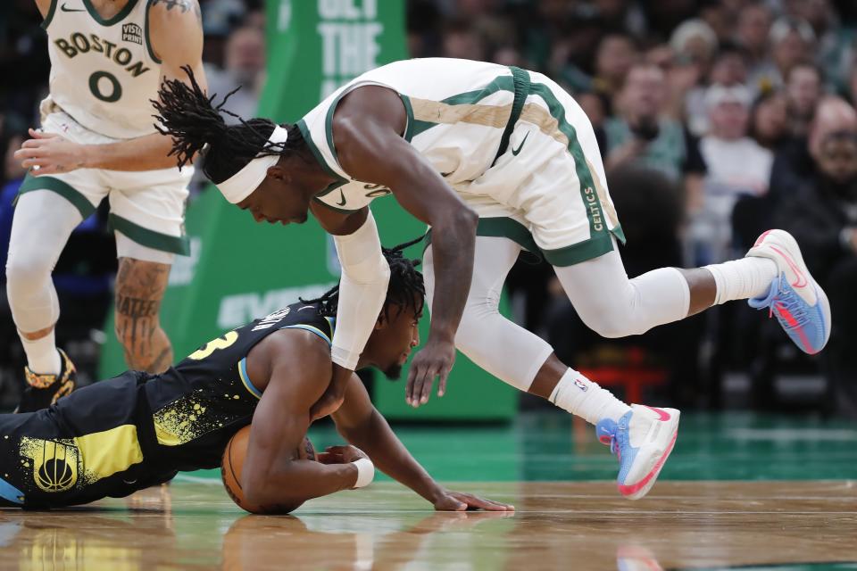 Boston Celtics' Jrue Holiday, right, and Indiana Pacers' Aaron Nesmith (23) battle for a loose ball during the first half of an NBA basketball game, Tuesday, Jan. 30, 2024, in Boston. (AP Photo/Michael Dwyer)