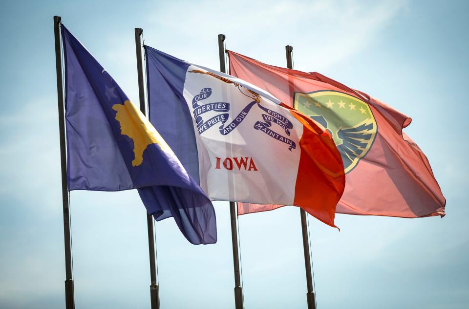The Iowa flag flies with the flag of the Republic of Kosovo and the flag of the Kosovo Security Force at the Ministry of Defense in Pristina, Kosovo, Tuesday, Sept. 18, 2018