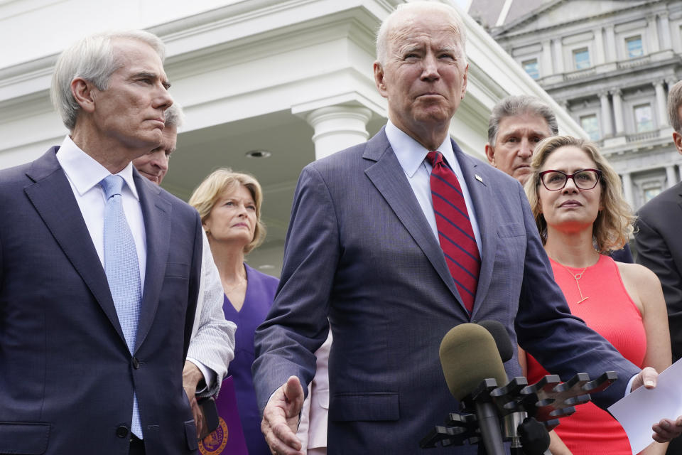 FILE - President Joe Biden, with a bipartisan group of senators, speaks June 24, 2021, outside the White House in Washington. From left are, Sen. Rob Portman, R-Ohio, Sen. Lisa Murkowski, R-Alaska, Biden, Sen. Joe Manchin, D-W.Va., and Sen. Kyrsten Sinema, D-Ariz. The decision by Sinema to leave the Democratic Party raised the prospect of a tumultuous three-way race in one of the most politically competitive states in the U.S. It set off a scramble among potential Democratic and Republican candidates to assess whether they could win their party’s nomination. (AP Photo/Jacquelyn Martin, File)