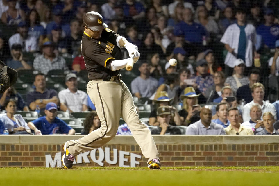 San Diego Padres' Manny Machado gets his 1,499th career hit, an RBI single off Chicago Cubs relief pitcher Rowan Wick, scoring Jurickson Profar during the eighth inning of a baseball game Monday, June 13, 2022, in Chicago. (AP Photo/Charles Rex Arbogast)