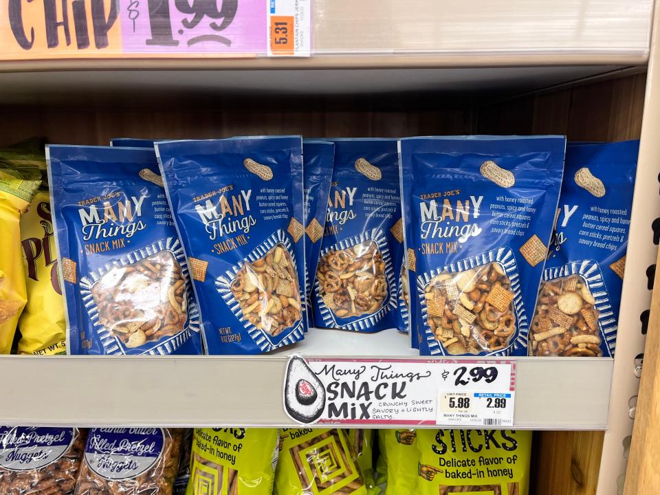 Blue bags of Trader Joe's Many Things snack mix on shelves