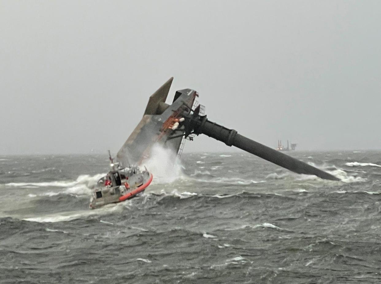 Rescuers search for missing crew members April 13, 2021, near the capsized Seacor Power.