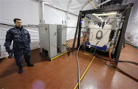 The Field Deployable Hydrolysis System used to destroy and neutralize chemical weapons is watched by U.S. Navy Commander Bill Speaks as it sits aboard the MV Cape Ray before its deployment from the NASSC0-Earl Shipyard in Portsmouth, Virginia, in this January 2, 2014 file photo. REUTERS/Larry Downing/Files