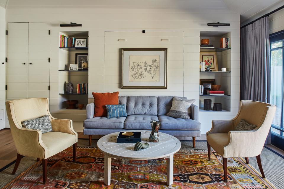 “They’re the Airbnb of their friend group, so it’s almost always got a guest,” Martin says of the nautical-inspired guest house that doubles as Tony’s office. A West Elm sofa and vintage sketch conceal the Murphy bed, and an abstract Jonathan Mess sculpture adds eye candy to the coffee table.