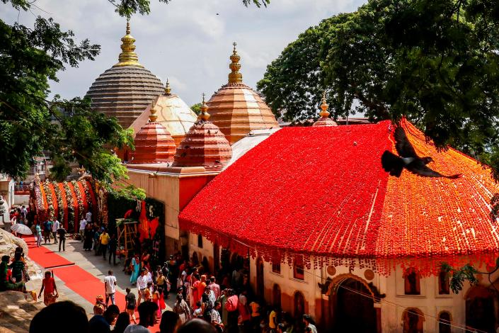 Devotees visit the Kamakhya Temple, decorated with floral garlands.