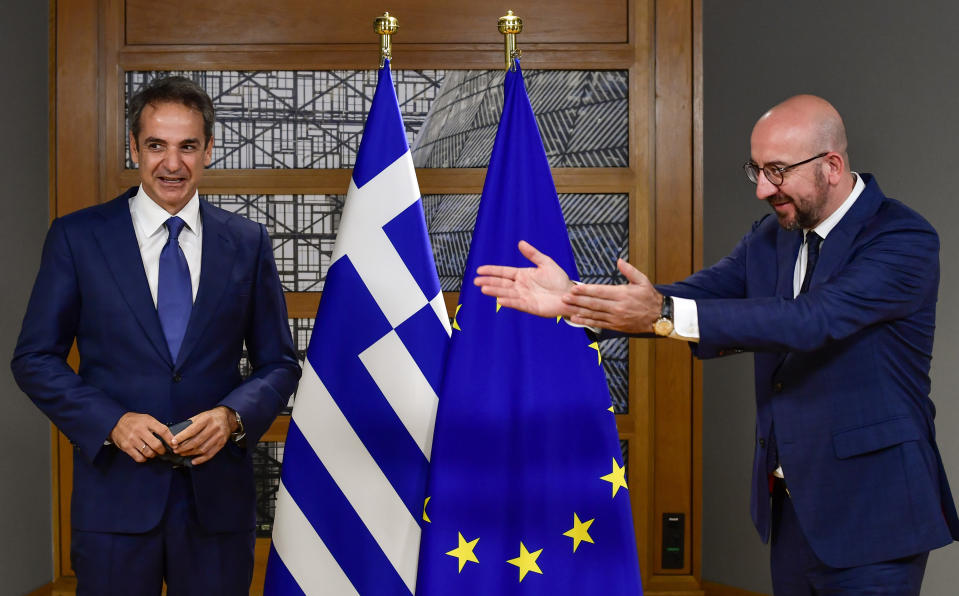 European Council President Charles Michel, right, greets Greek Prime Minister Kyriakos Mitsotakis ahead of a meeting on the sidelines of an EU summit at the European Council building in Brussels, Thursday, Oct. 1, 2020. European Union leaders are meeting to address a series of foreign affairs issues ranging from Belarus to Turkey and tensions in the eastern Mediterranean. (John Thys, Pool via AP)