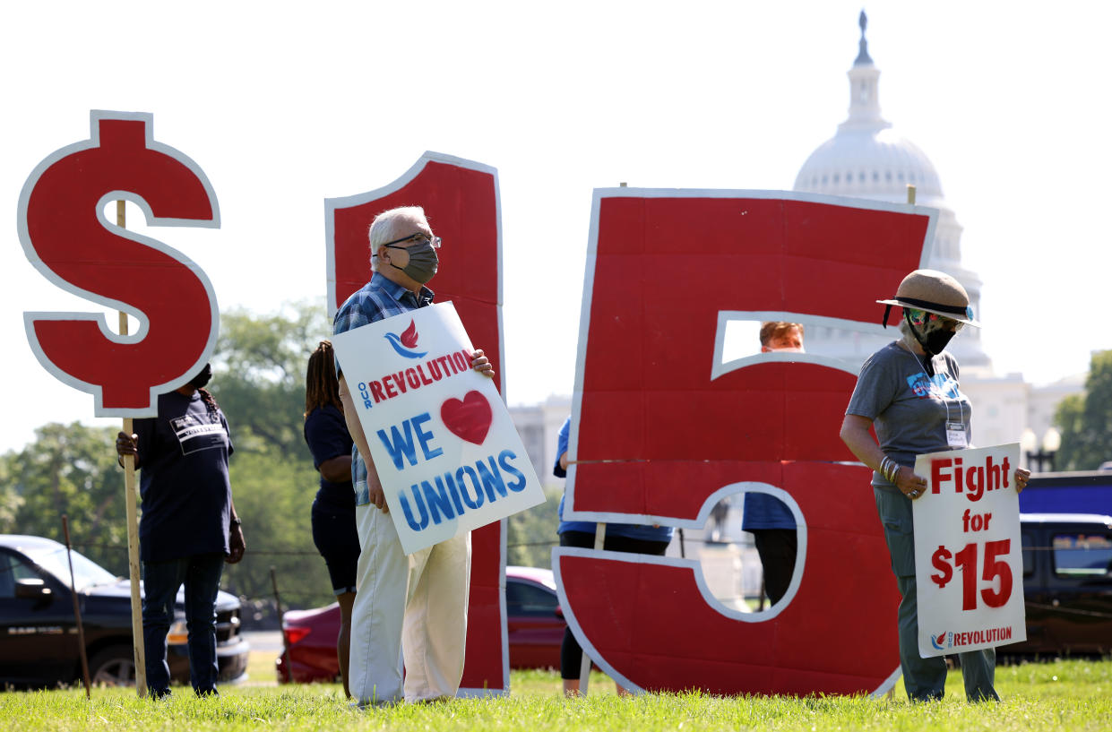 WASHINGTON, DC - MAY 19: Labor activists hold a rally in support of raising the minimum wage to $15 an hour on the National Mall on May 19, 2021 in Washington, DC. Members of the Service Employee International Union (SEIU) organized the rally in support of striking McDonald's workers who are demanding a wage increase. (Photo by Kevin Dietsch/Getty Images)