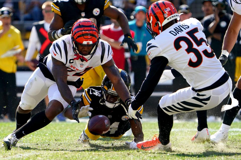 Pittsburgh Steelers wide receiver Ray-Ray McCloud (14), center, dives to recover a fumble forced by Cincinnati Bengals cornerback Darius Phillips (23), left, during a Week 3 NFL football game, Sunday, Sept. 26, 2021, at Heinz Field in Pittsburgh.