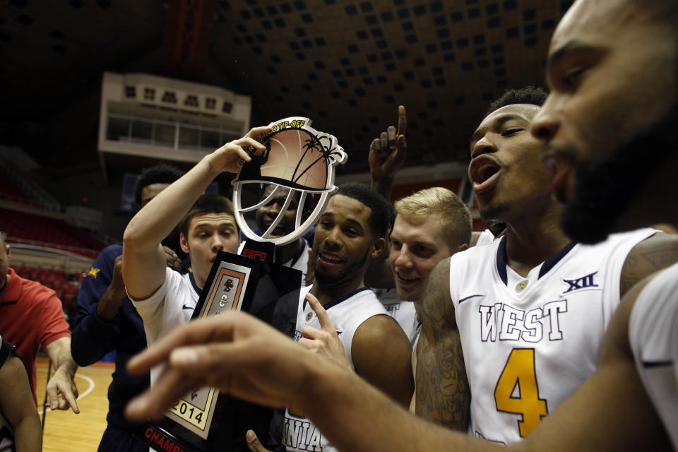 West Virginia players celebrate after winning the Puerto Rico Tip-Off tournament (AP)