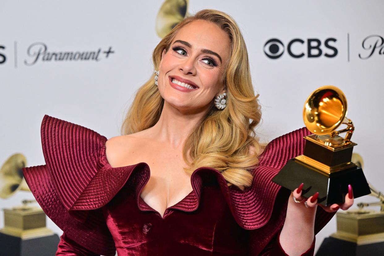 Adele poses with the award for Best Pop Solo Performance for 