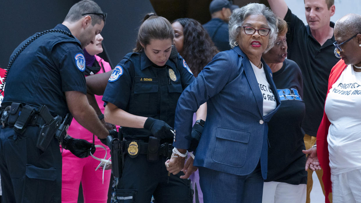 Rep. Joyce Beatty, D-Ohio, chairwoman of the Congressional Black Caucus is taken into custody by U.S. Capitol Police officers in the Hart Senate Office Building, after a demonstration supporting the voting rights, on Capitol Hill, Thursday, July 15, 2021, in Washington. (AP Photo/Jose Luis Magana)