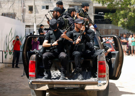 Members of Palestinian security forces loyal to Hamas ride a truck outside a Hamas-run military court where alleged collaborators with Israel are prosecuted, in Gaza City May 21, 2017. REUTERS/Mohammed Salem