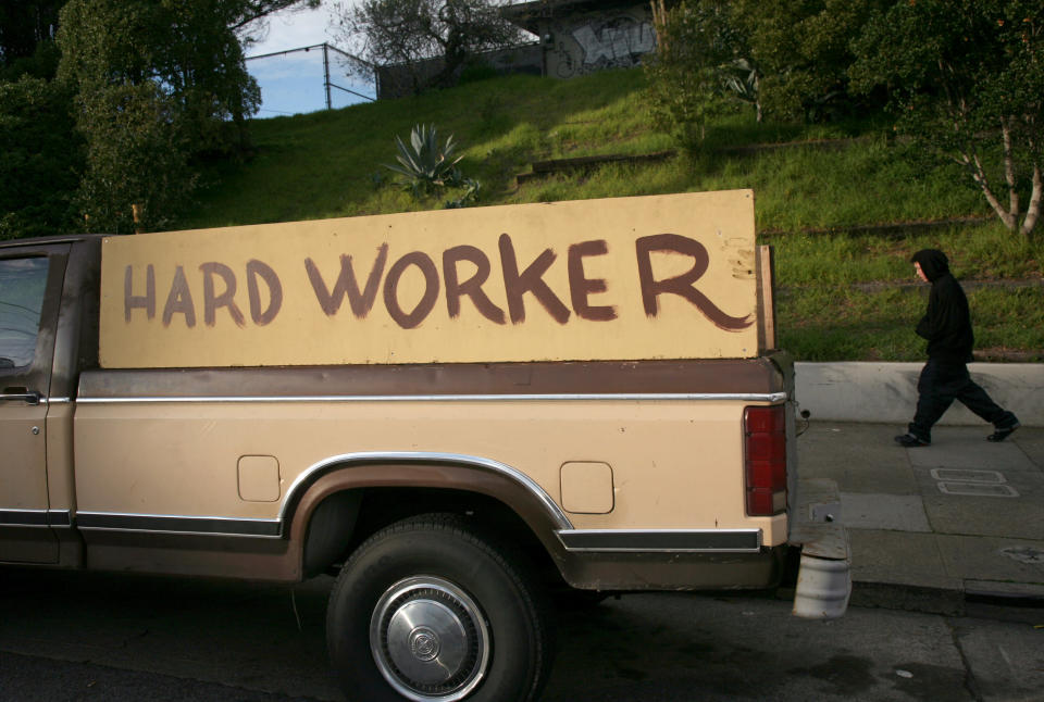 handmade sign painted on the side of a pickup truck reading "hard worker" is shown in San Francisco