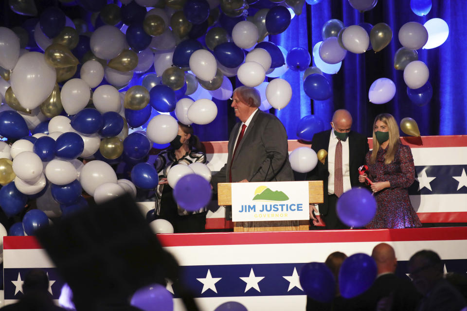 West Virginia Gov. Jim Justice, center, celebrates his reelection at The Greenbrier Resort, Tuesday, Nov. 3, 2020, in White Sulphur Springs, W.Va. (AP Photo/Chris Jackson)