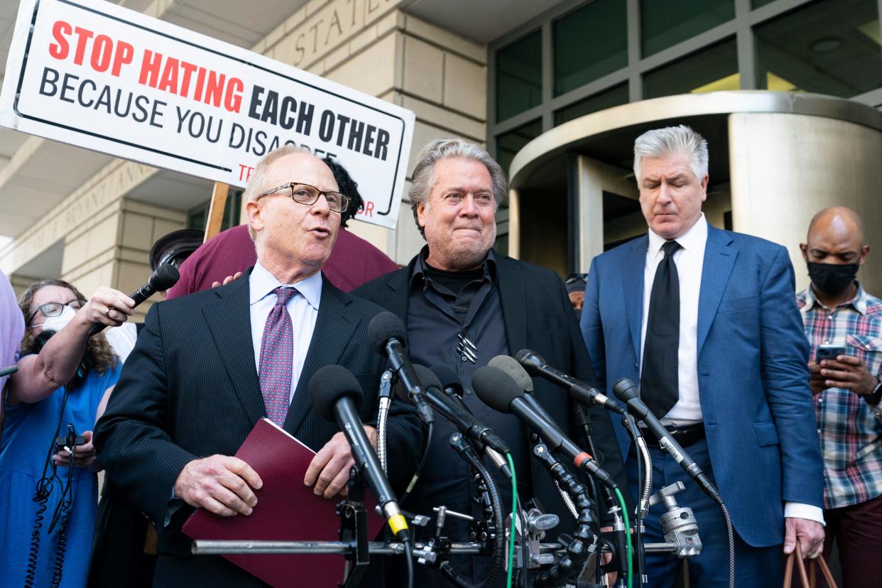 Former White House strategist Steve Bannon, center, talks to reporters as he leaves federal court in Washington in July. Bannon, a longtime ally of Donald Trump, was convicted of contempt charges for defying a congressional subpoena from the House committee investigating the Jan. 6 insurrection at the U.S. Capitol.